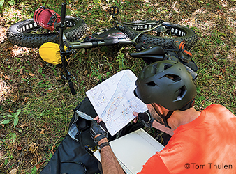 image of biker looking at a map.