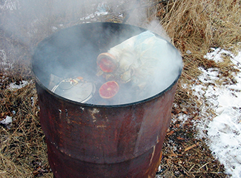 image of trash in a 55-gallon burn barrel.