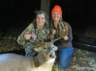 photo of hunters with trophy buck taken during a women's hunt in Itasca State Park.